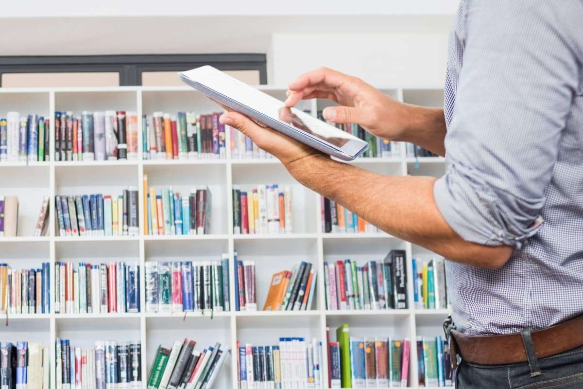 busy public library or town hall with residents using laptops and phones on free council WiFi